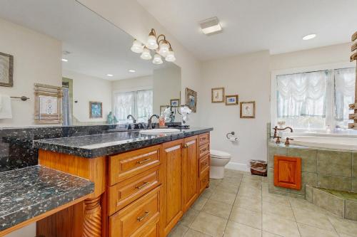 a bathroom with a sink and a tub and a toilet at CJ314FLR The Mermaid Manor in Cudjoe Key