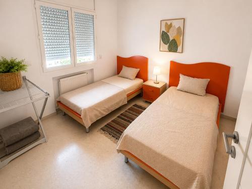 a bedroom with two beds and a window at Cozy Stay appartement in Sukrah