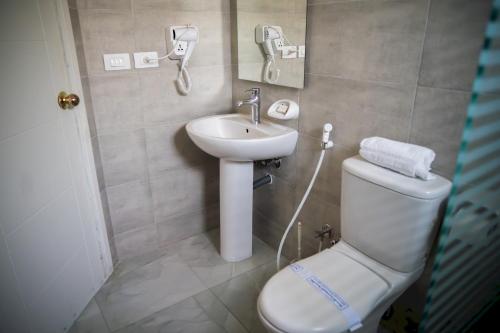 a bathroom with a toilet and a sink at 325 · 2BR Townhouse 2 Bath TV in Sheikh Zayed