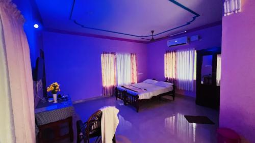 a room with a bed in a purple room at Harbour villa 1 in Trivandrum