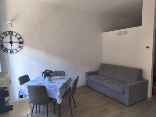 a living room with a table and a couch at Il Flat Arona Centro, Le Dimore del Corso in Arona