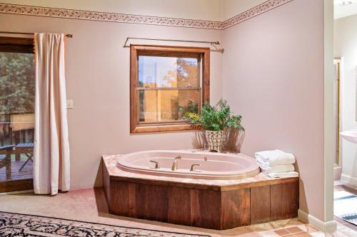 a large bathroom with a tub and a window at Point Au Roche Lodge in Plattsburgh