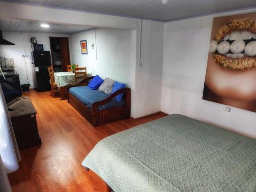 a bedroom with a bed and a couch in a room at Serena in Maldonado