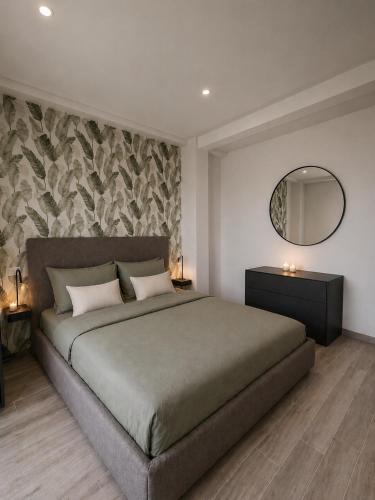a bedroom with a large bed and a mirror at Lake View Apartament 10 - Free Parking & Terrace in Cadegliano Viconago