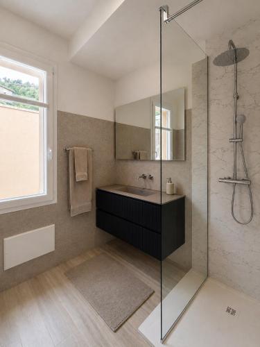 a bathroom with a sink and a glass shower at Lake View Apartament 10 - Free Parking & Terrace in Cadegliano Viconago