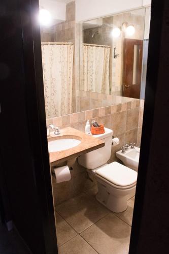 a bathroom with a sink and a toilet at Hotel Samka in Salta