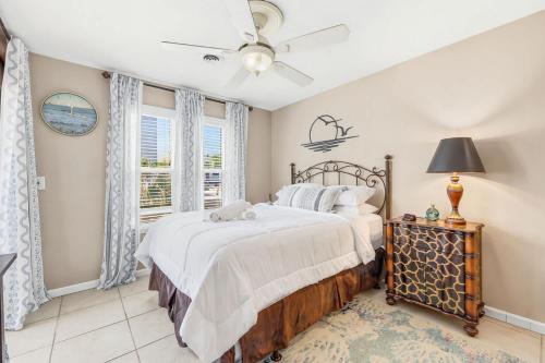 a bedroom with a bed and a window at Cherry Grove Condo Steps to Beach Sleeps 8 in Myrtle Beach