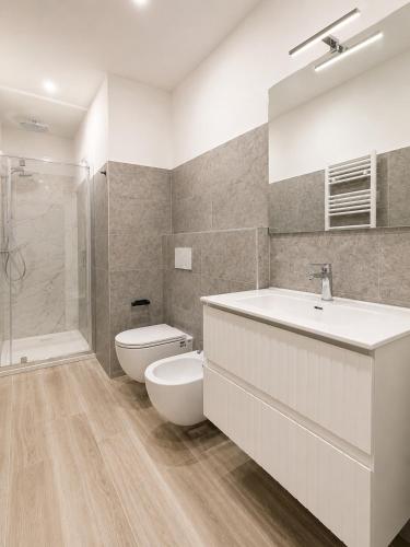 a bathroom with a sink and a toilet and a shower at Lake View Apartament 1 - Free Parking & Terrace in Cadegliano Viconago