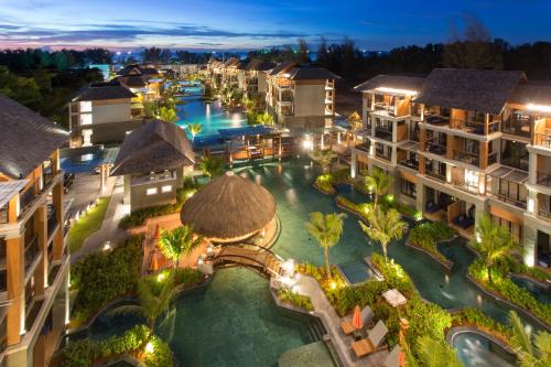 an aerial view of a resort pool at night at Mai Holiday by Mai Khaolak - Adult Zone in Khao Lak