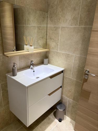 a bathroom with a white sink and a mirror at Appartement 4 personnes in Sainte-Maxime