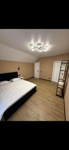 a bedroom with a bed and a ladder in it at House on The Hill Bukovel in Palyanytsya