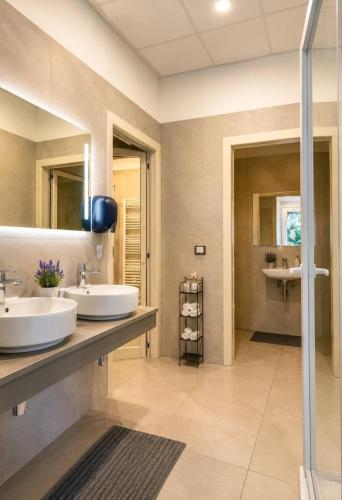 a bathroom with two sinks and a shower at Hotel Mazzocca in Caramanico Terme