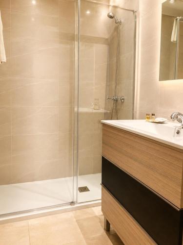 a bathroom with a shower and a sink at Hotel Hispania in Zaragoza