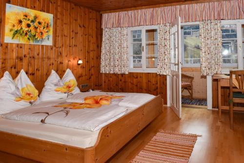 a bedroom with a bed with flowers on it at Weitgasserhof in Schladming