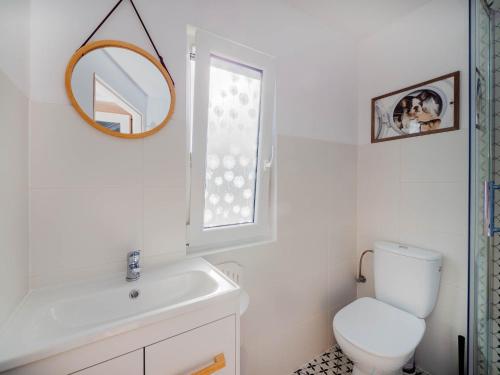 a bathroom with a toilet and a sink and a mirror at Szum Fal in Rusinowo