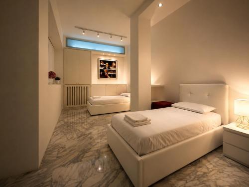 a bedroom with a white bed and a couch at La Galleria Milano - 160 sqm Design Apartment, Spa & Parking in Milan
