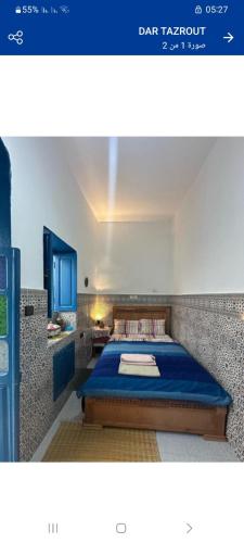 a bedroom with a blue bed in a room at DAR TAZROUT in Tangier