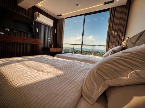 a bedroom with two beds and a large window at Montaza World inn in Alexandria