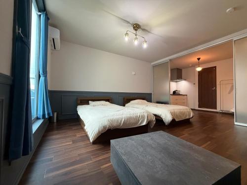 a bedroom with two beds and a table at Telegraph in Kamakura