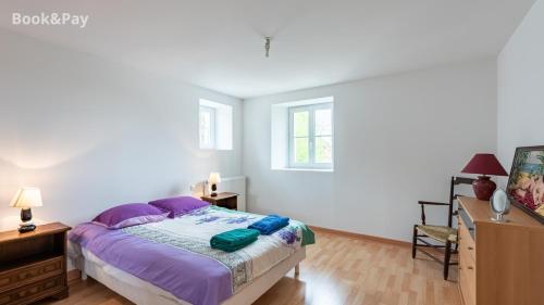 a bedroom with a bed and a dresser and window at Eugénie in Saint-Quentin-de-Chalais