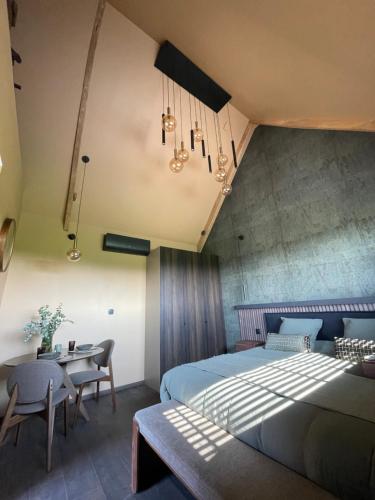 a bedroom with a bed and a table and chairs at La Gazolina in Boeseghem