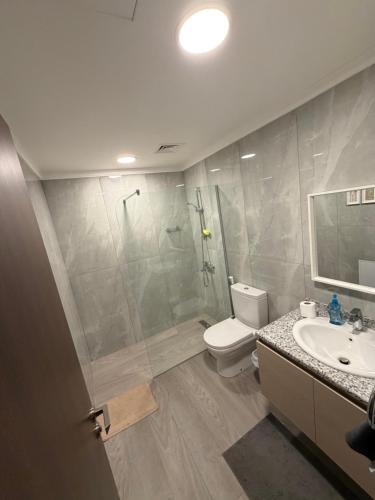 a bathroom with a shower and a toilet and a sink at Samara in Sowayma