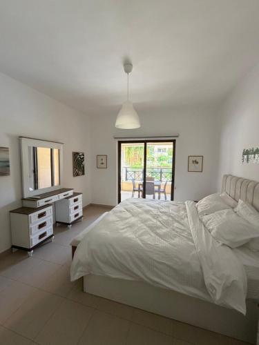 a bedroom with a bed and a dresser and a mirror at Samara in Sowayma