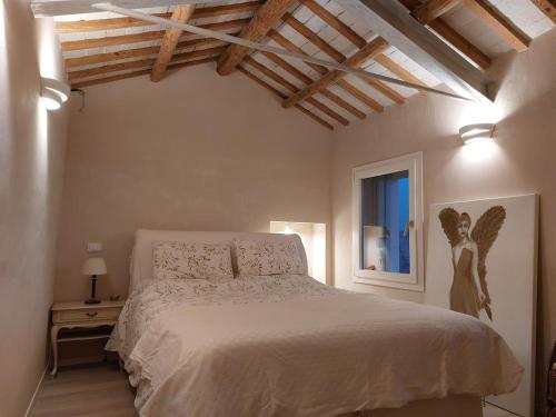 a bedroom with a bed with an angel picture on the wall at Fairytale old stonehouse in Brendola