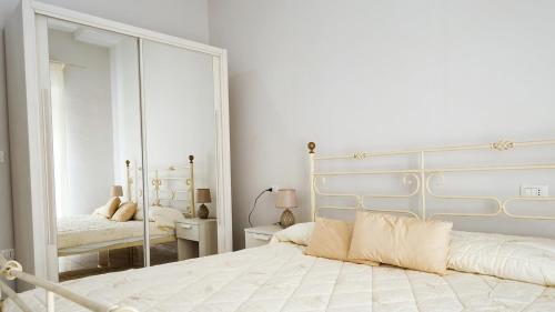 a bedroom with a large mirror and a bed at Castelsardo Appartment in Castelsardo