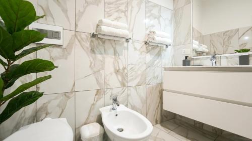 a bathroom with a toilet and a sink at Castelsardo Appartment in Castelsardo