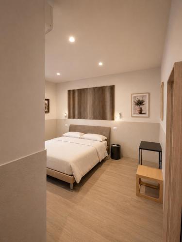a bedroom with a large bed and a table at B&B Luna Rossa in Altamura
