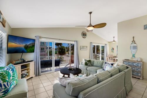 a living room with a couch and a table at Beach You To It in Anna Maria