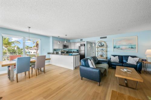 a living room with a couch and a table at Beachfront Waves in Bradenton Beach