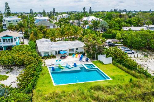an aerial view of a house with a swimming pool at Beachfront Bungalow in Holmes Beach
