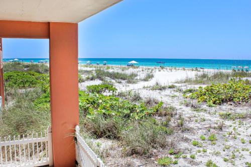 a view of the beach from the balcony of a beach house at Beachfront Waves in Bradenton Beach