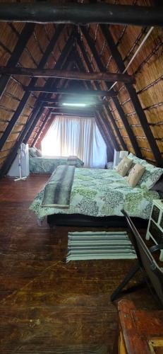 a bedroom with a bed in a attic at Eagles Nest in Rustenburg