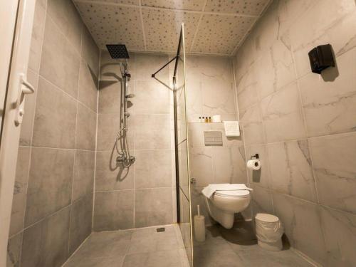 a bathroom with a shower and a toilet at Babil Hotel in Antalya