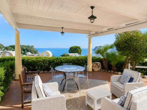 a patio with a table and chairs and the ocean at Maridea - Villetta Brezza Marina in Ponza