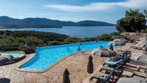 a swimming pool with a view of a lake at Camping 4 étoiles - Piscine - ccbfiee in Olmeto