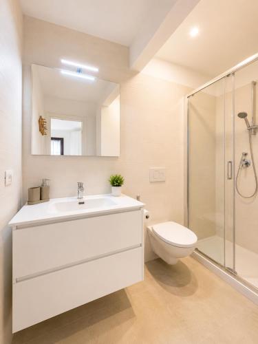 a bathroom with a sink and a toilet and a shower at Casa del Marinaio - Agenzia Cocal in Caorle