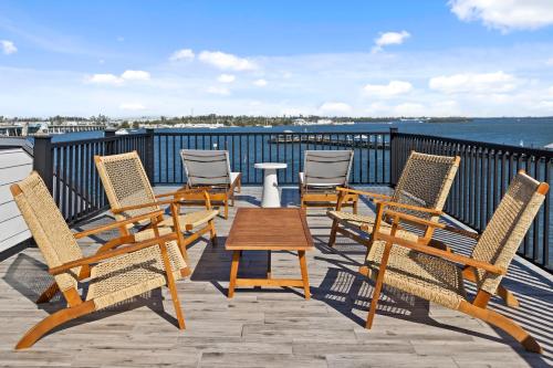 a group of chairs and a table on a deck at Big Nauti in Bradenton Beach