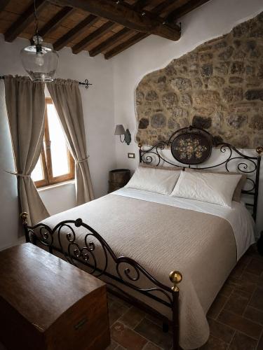 a bedroom with a bed in a room with a window at C'era una volta in Abbadia San Salvatore