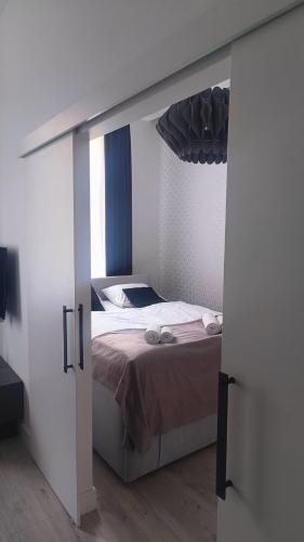 a bedroom with a bed with an open door at apartament centrum-rynek Gorzów in Gorzów Wielkopolski