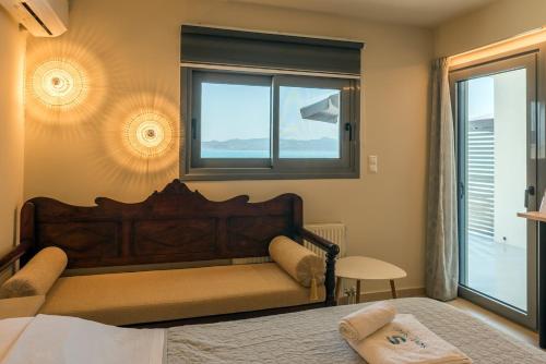 a bedroom with a large bed and a window at Sea Salt Studios in Nerántza