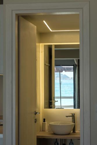 a bathroom with a sink and a mirror at Sea Salt Studios in Nerántza