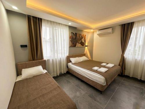 a hotel room with two beds in a room at Babil Hotel in Antalya