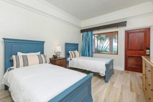 a bedroom with two beds and a window at The Buccaneer Beach & Golf Resort in Christiansted