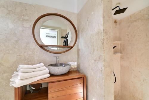 a bathroom with a sink and a mirror at apartement rooftop oceanfront - Hotel Aligio in Las Terrenas