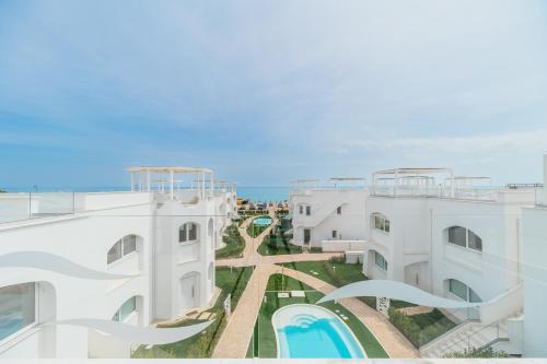 an aerial view of two white buildings and a swimming pool at Conero View in Marcelli