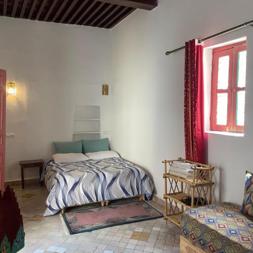 a bedroom with a bed in the corner of a room at Riad La Mentha Panoramic Terrace in Fes Medina in Fez